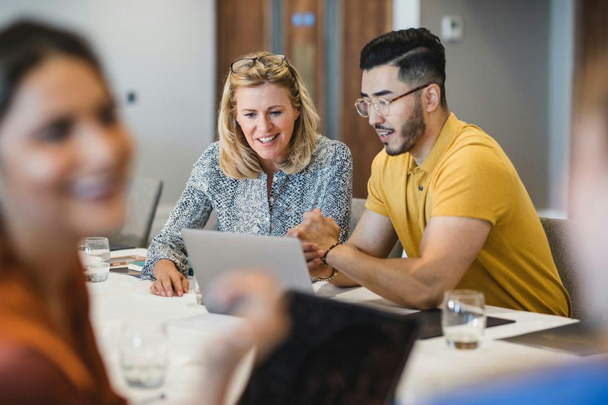 man and woman at computer working with purpose-built software