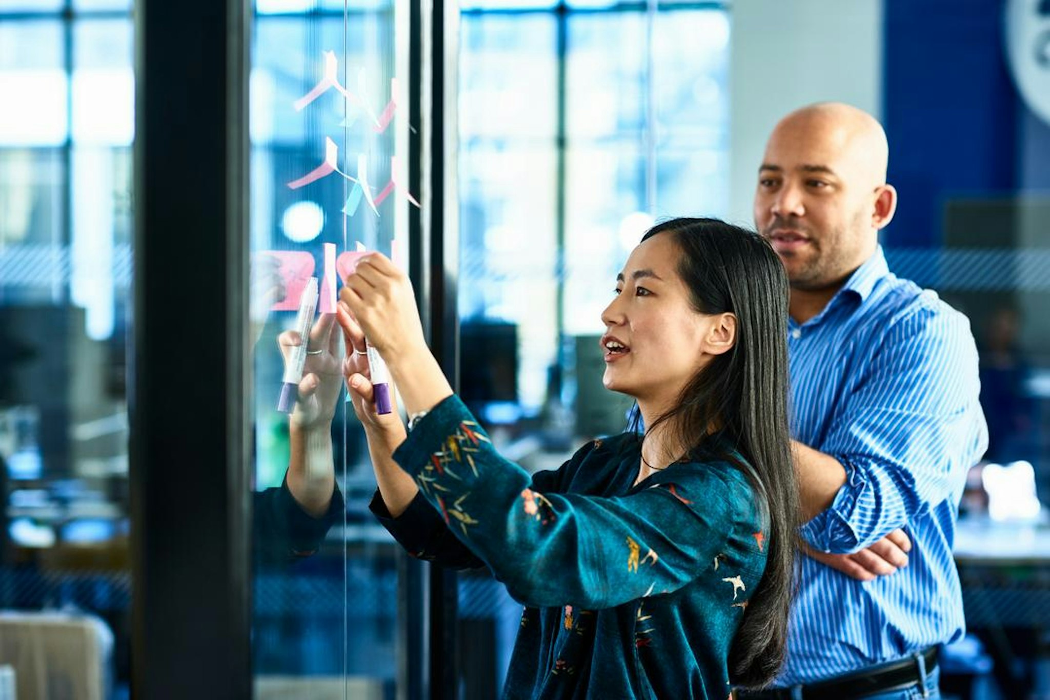 Two colleagues analysing IPO trends in preparation for their initial public offering