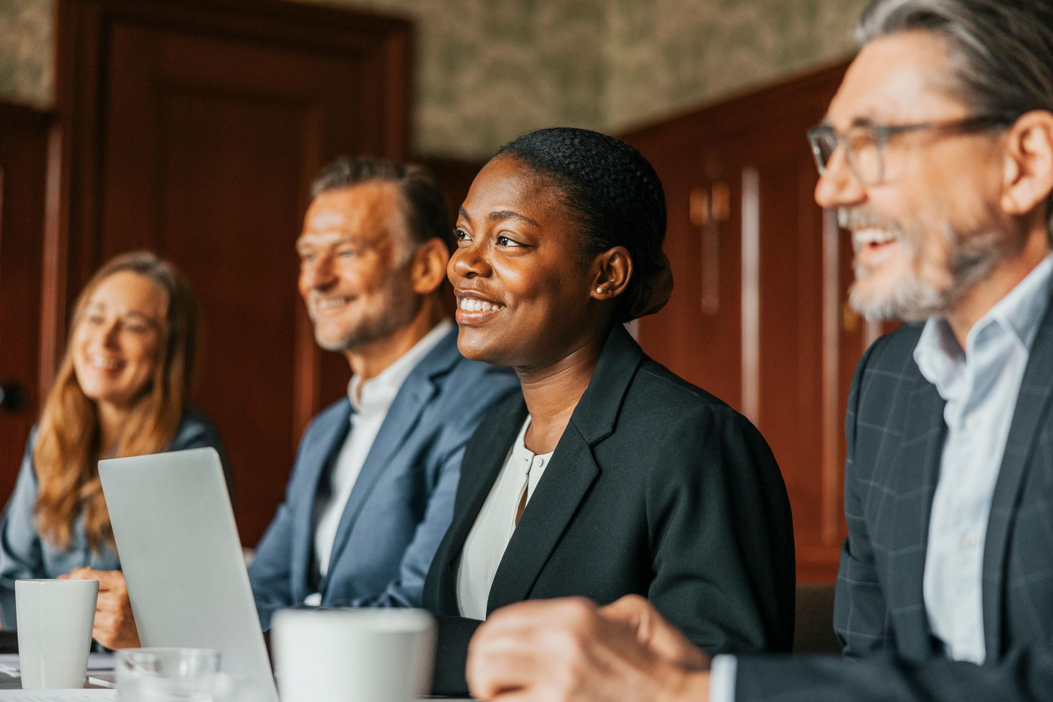 Professionals in a meeting about streamlining entity governance